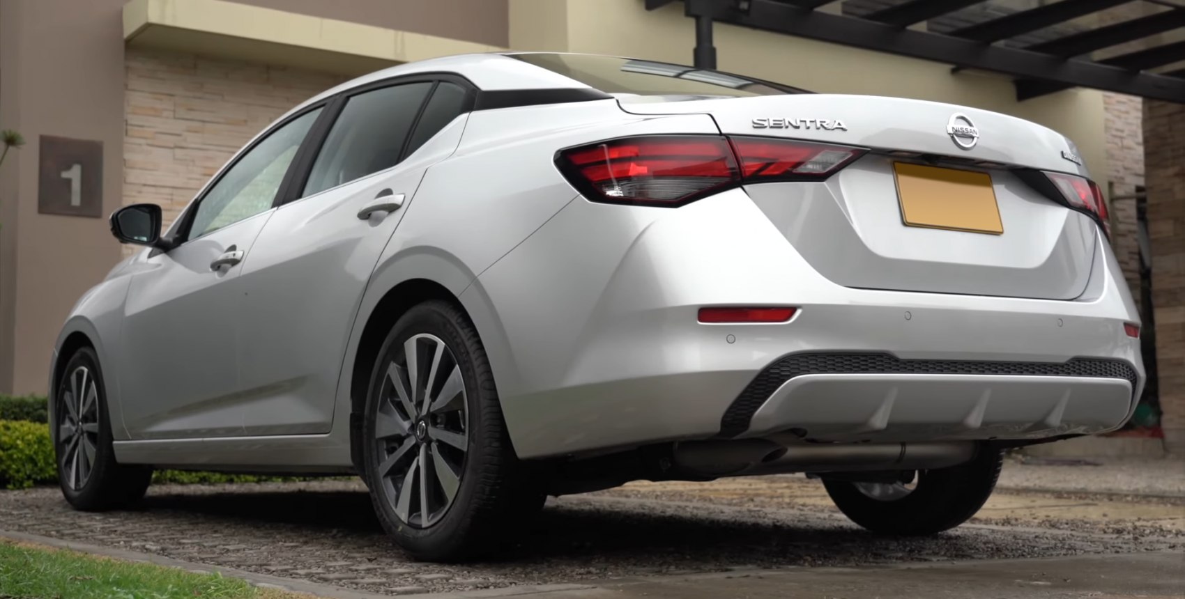 Rear and side view of a modern sedan with stylish taillights and alloy wheels