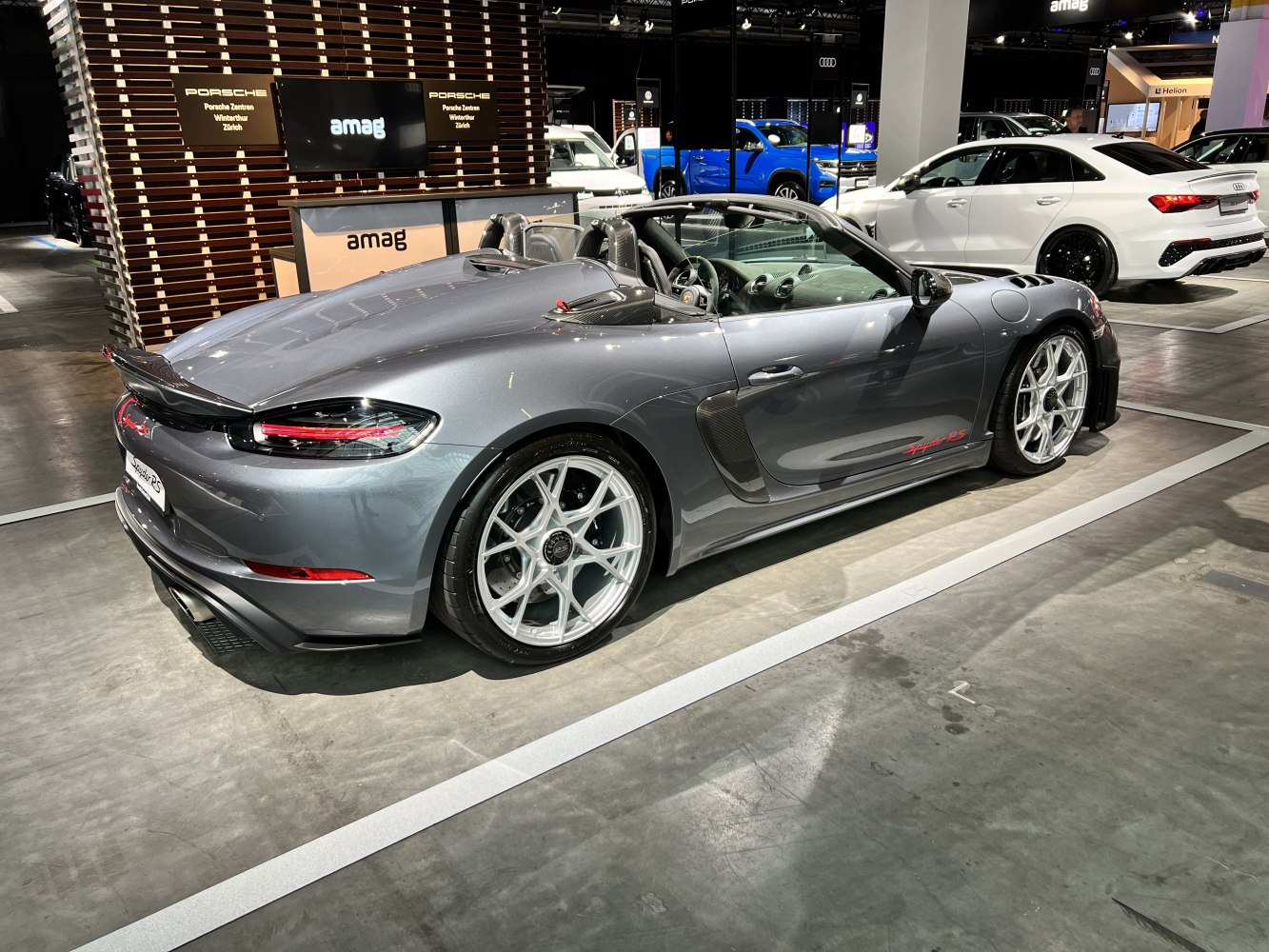 Rear and side view of convertible sports car with alloy wheels and aerodynamic design