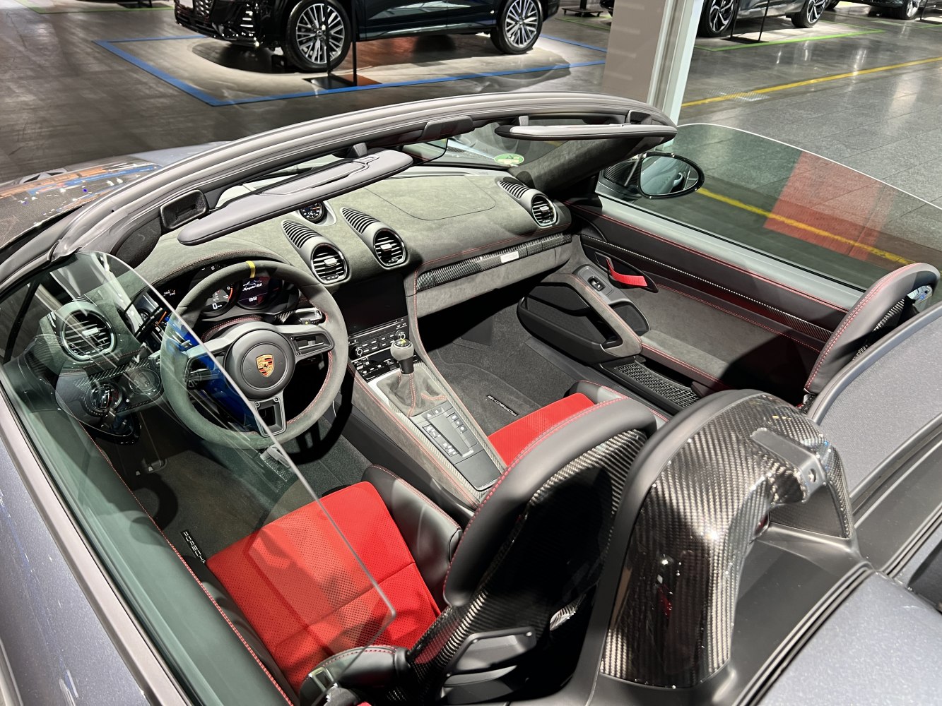 Sporty red seats with carbon fiber trim and detailed cockpit interior.