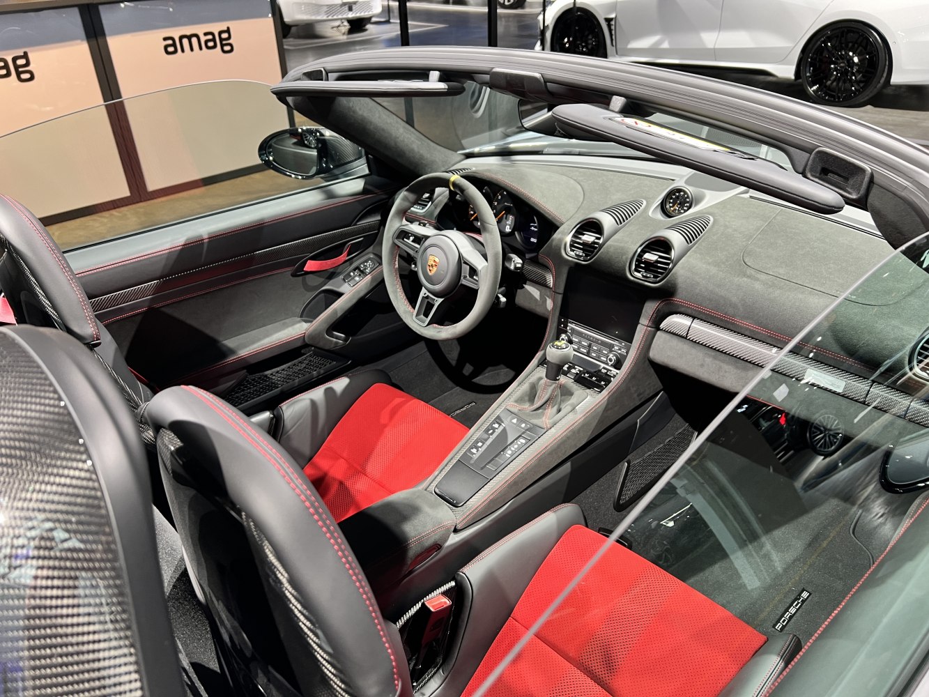 Sporty car interior with red sport seats and Alcantara dashboard