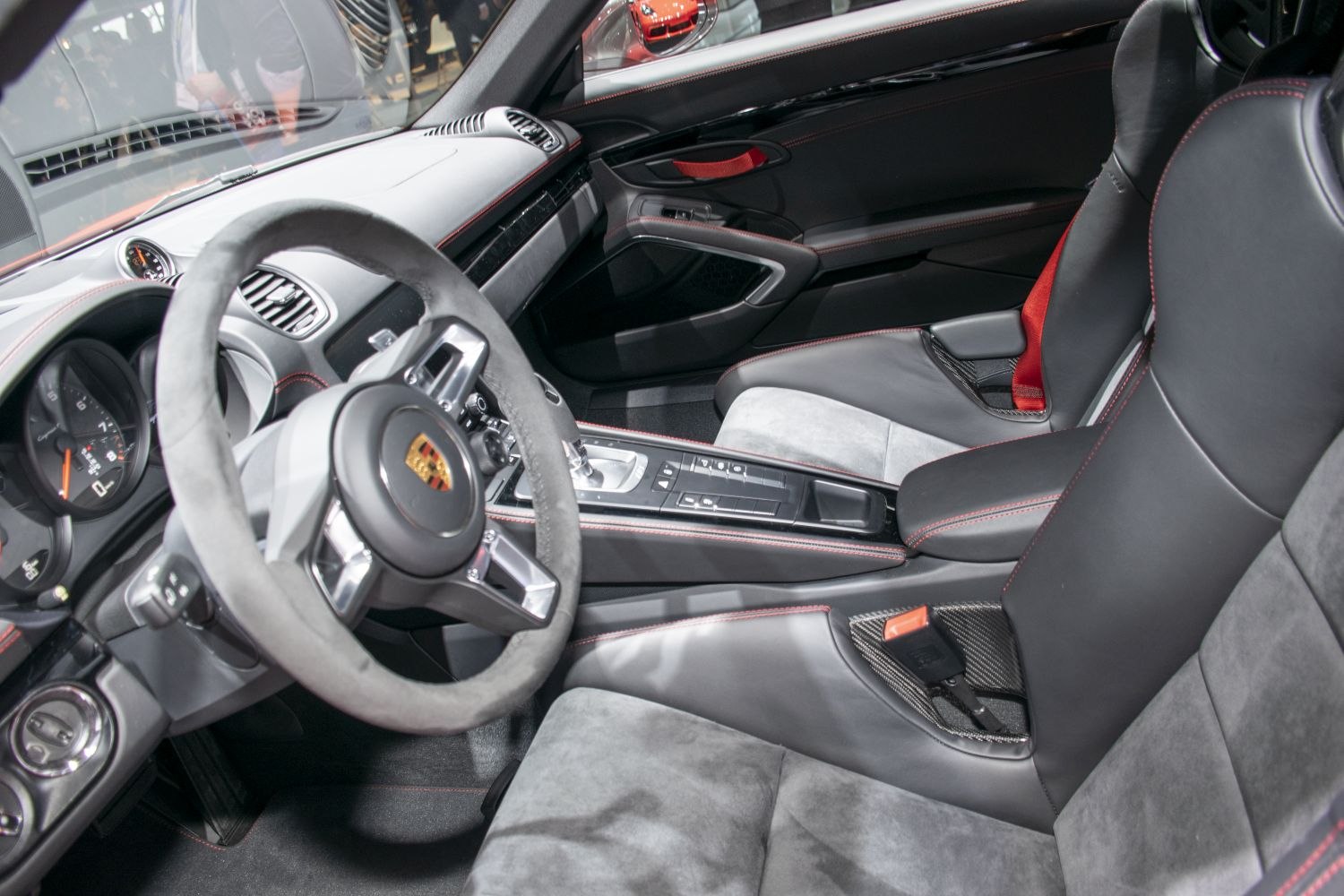 Luxury sports car interior with detailed dashboard and seats.