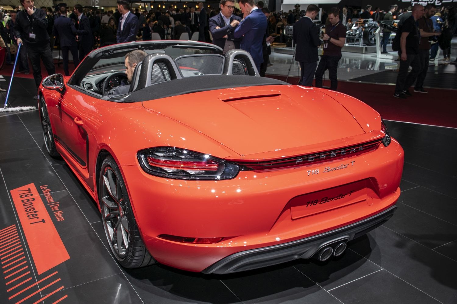 Red convertible roadster rear with dual exhaust and sporty wheels