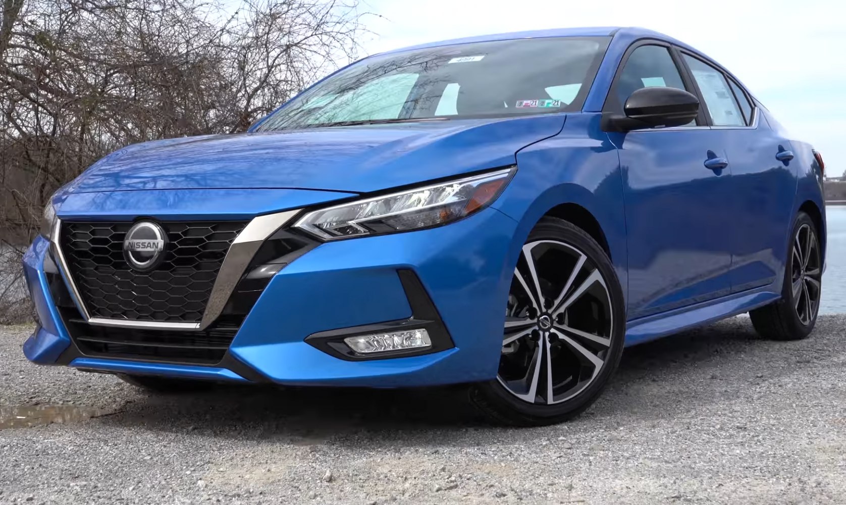 Blue sedan front with LED headlights and alloy wheels