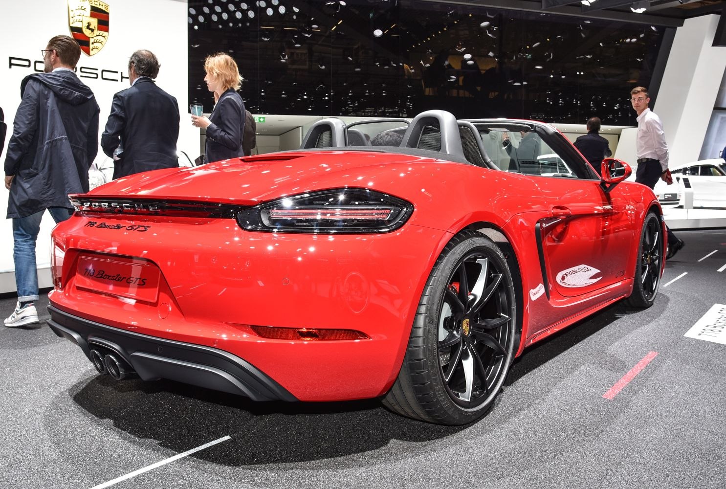 Rear view of red convertible with black alloy wheels and dual exhaust