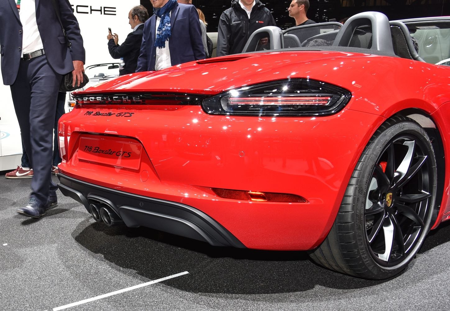 Rear view of red convertible with modern taillights and dual exhaust pipes