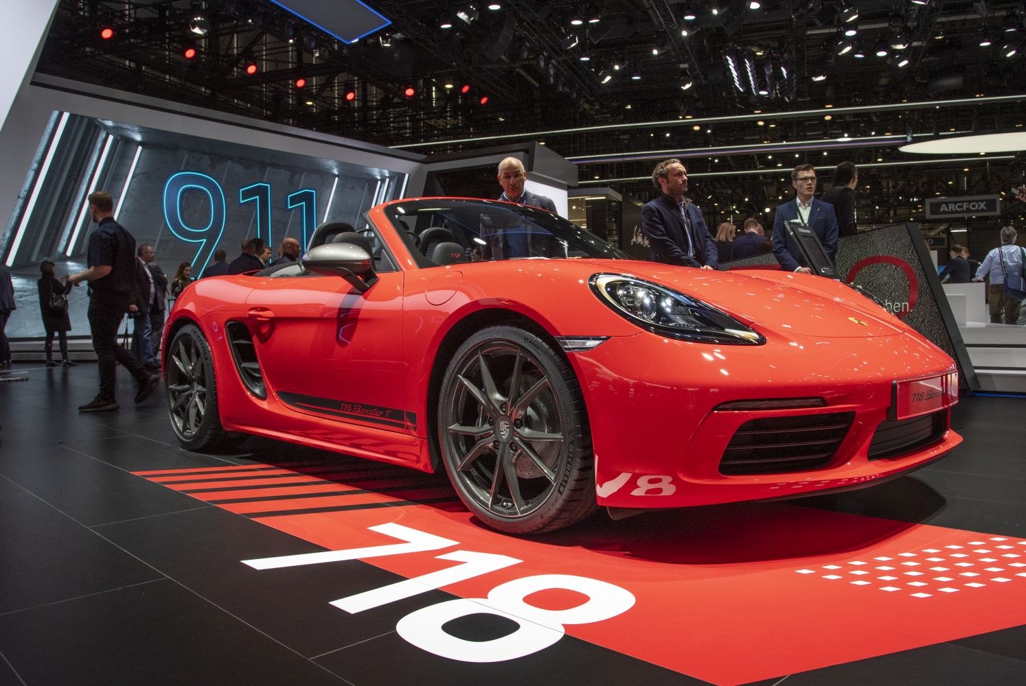Red convertible sports car with sleek headlights and alloy wheels