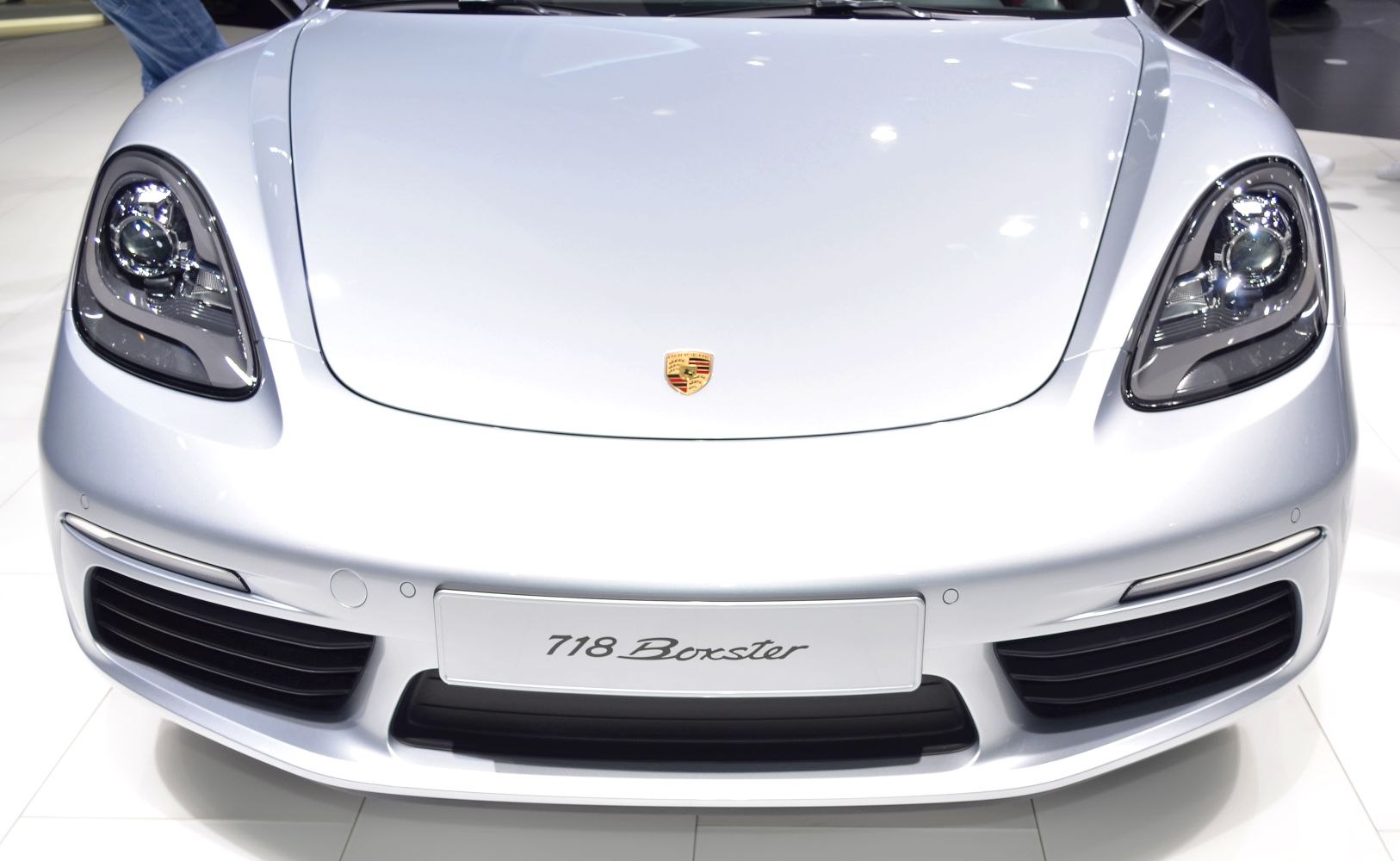 Front view showing headlights, grille, and badge of a sports roadster.