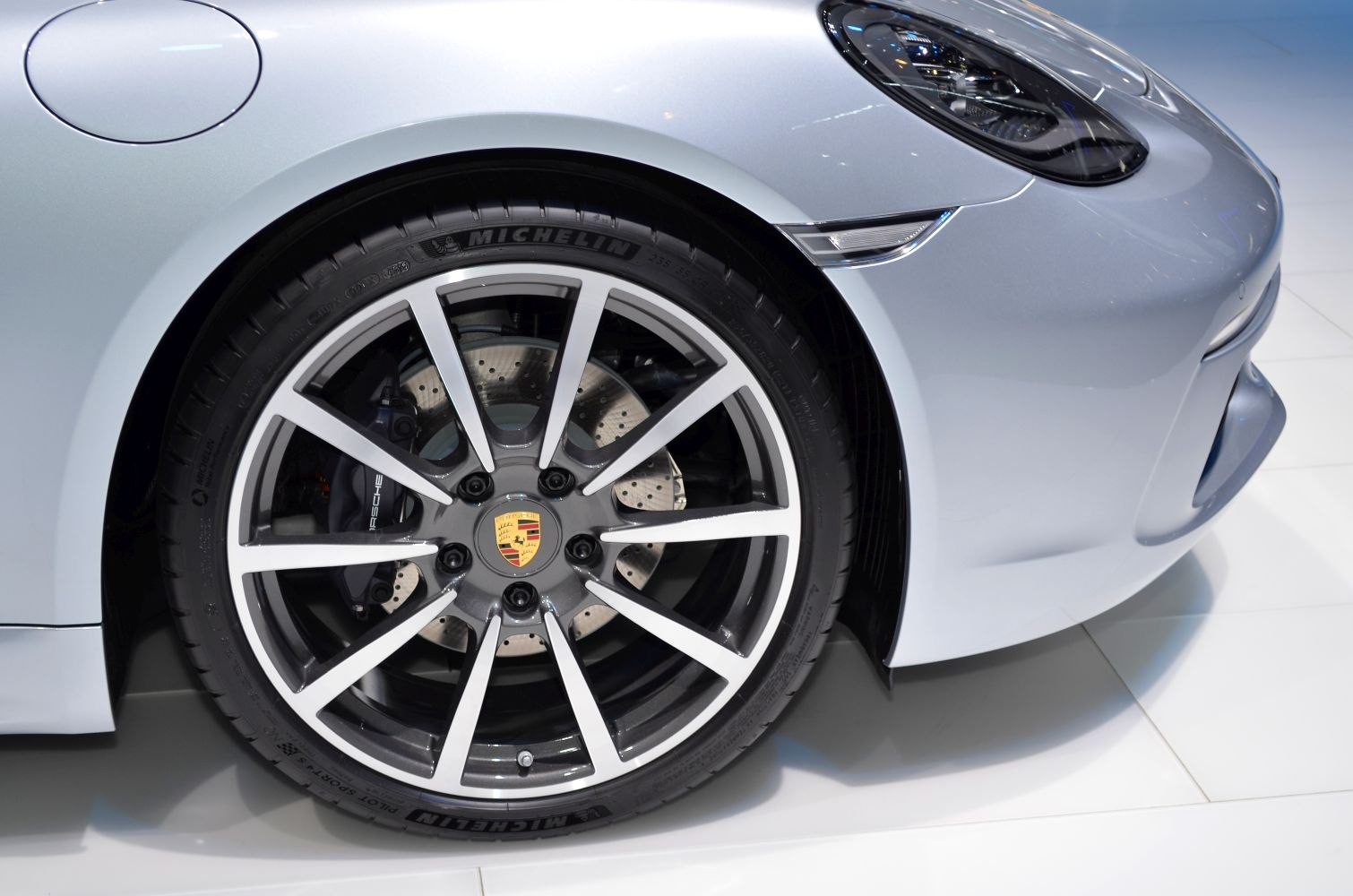 Front wheel with alloy rim, brake disc, and modern headlight design