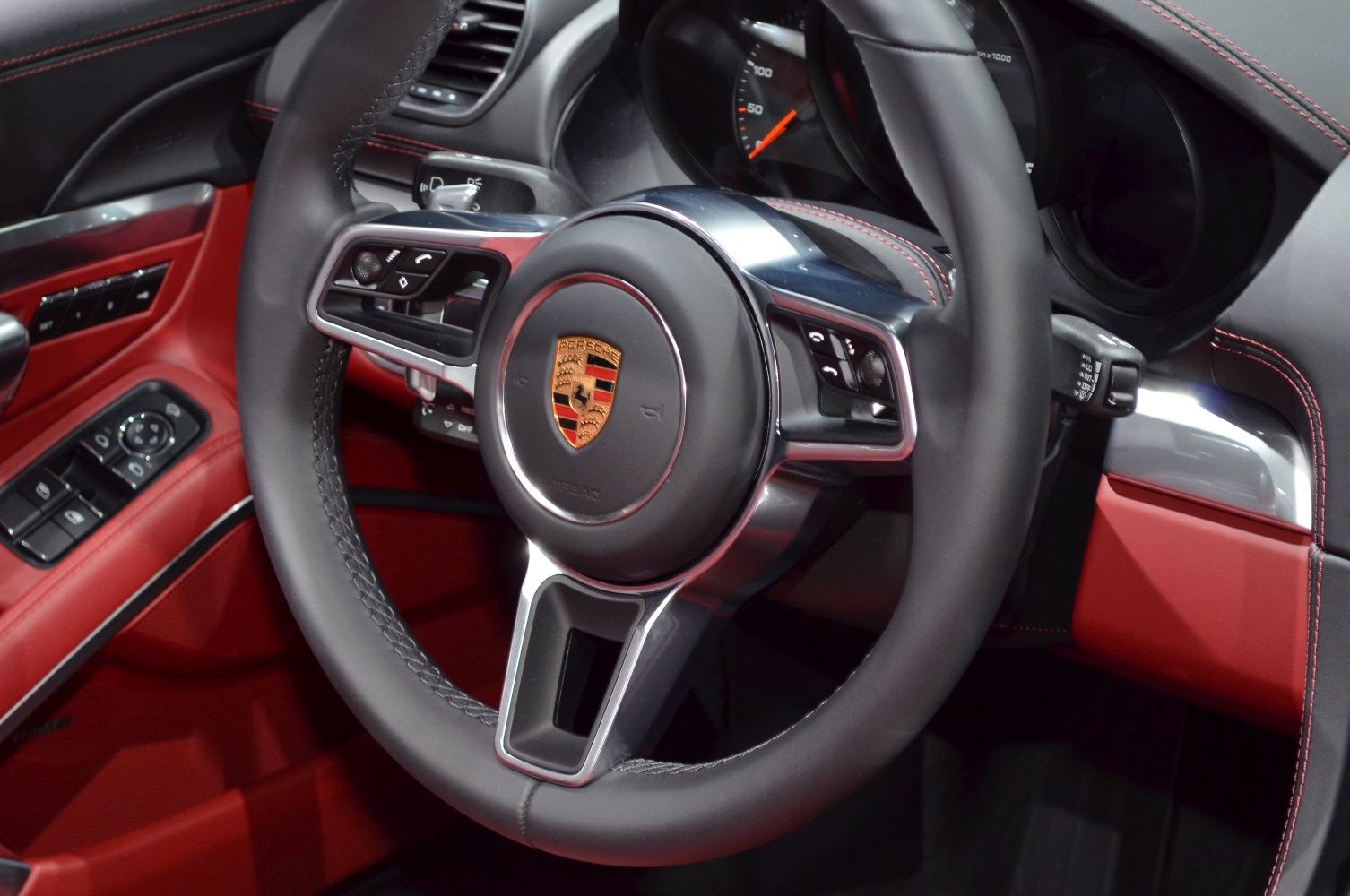 Steering wheel with control buttons and red leather interior trim