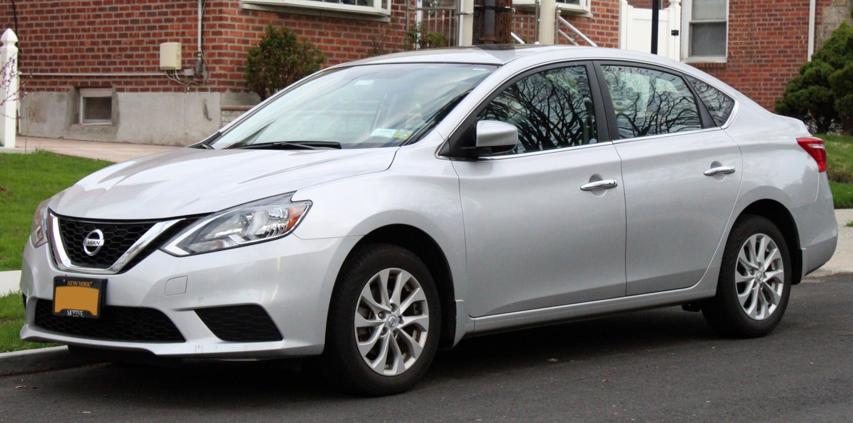 Silver sedan with alloy wheels and angular headlights