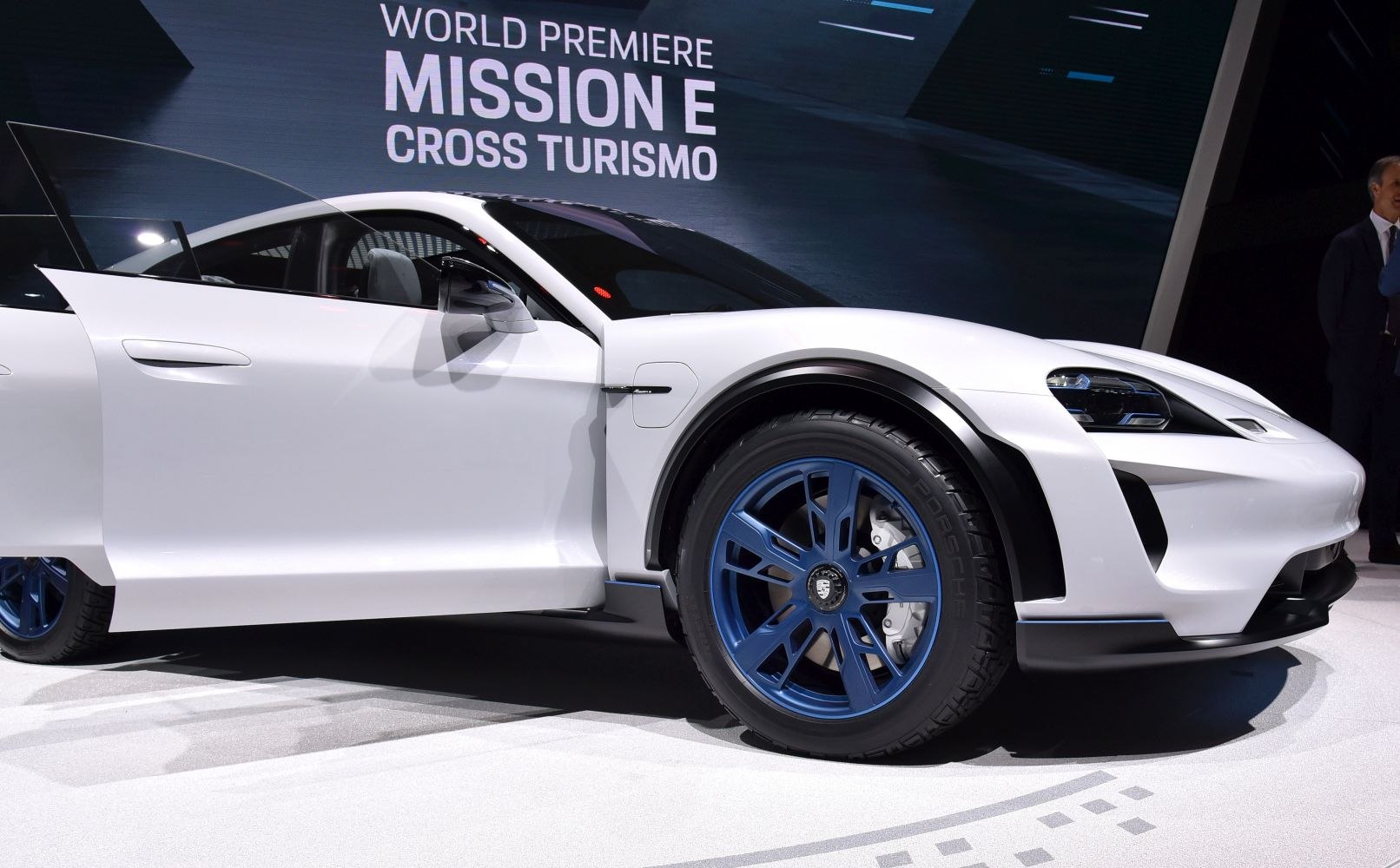 Electric SUV with distinctive blue wheels and aerodynamic body.