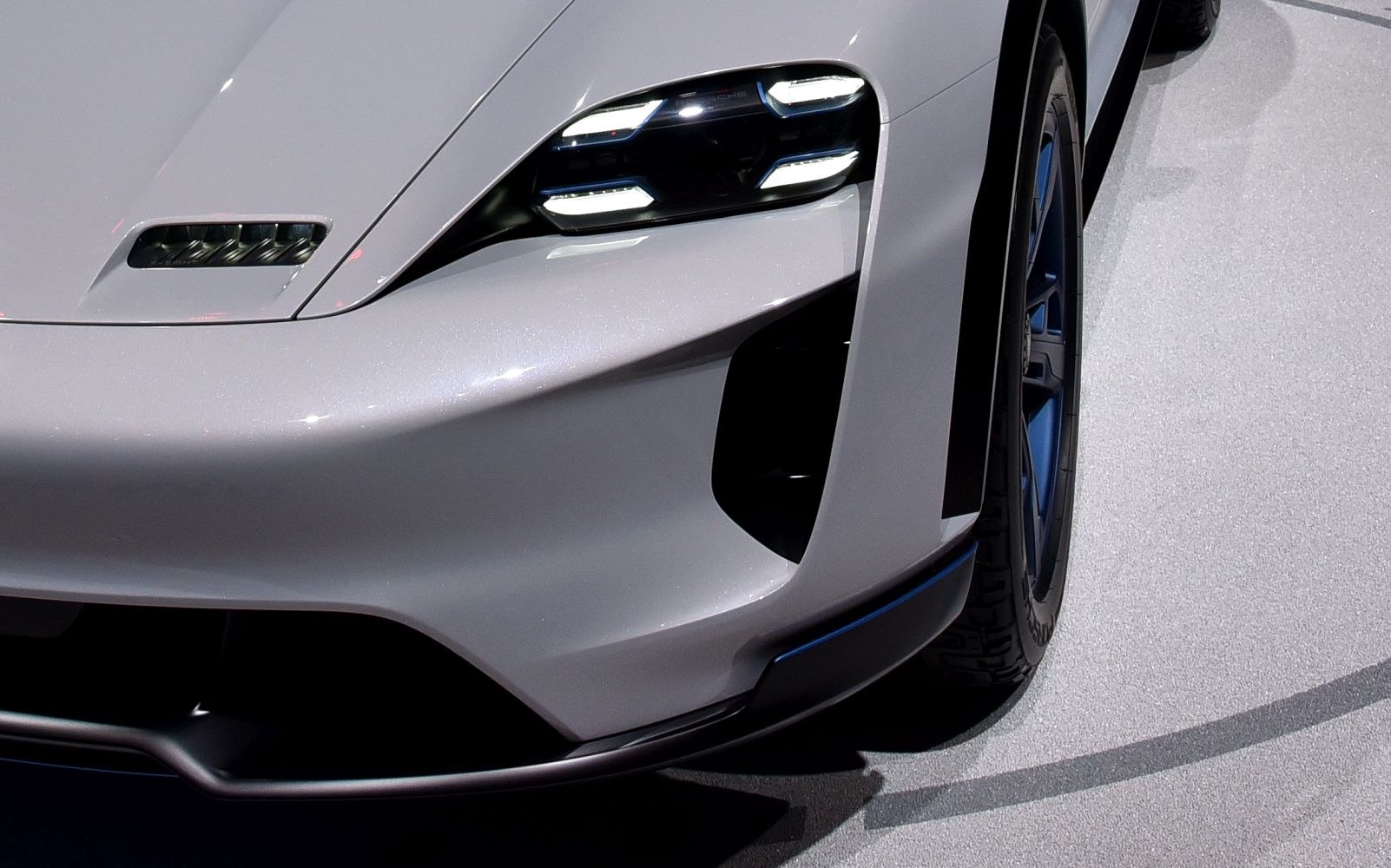 Close-up of futuristic front headlight and aerodynamic vent with wheel detail