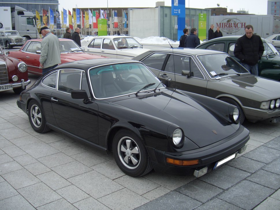 Black vintage coupe with round headlights and sleek bodyline