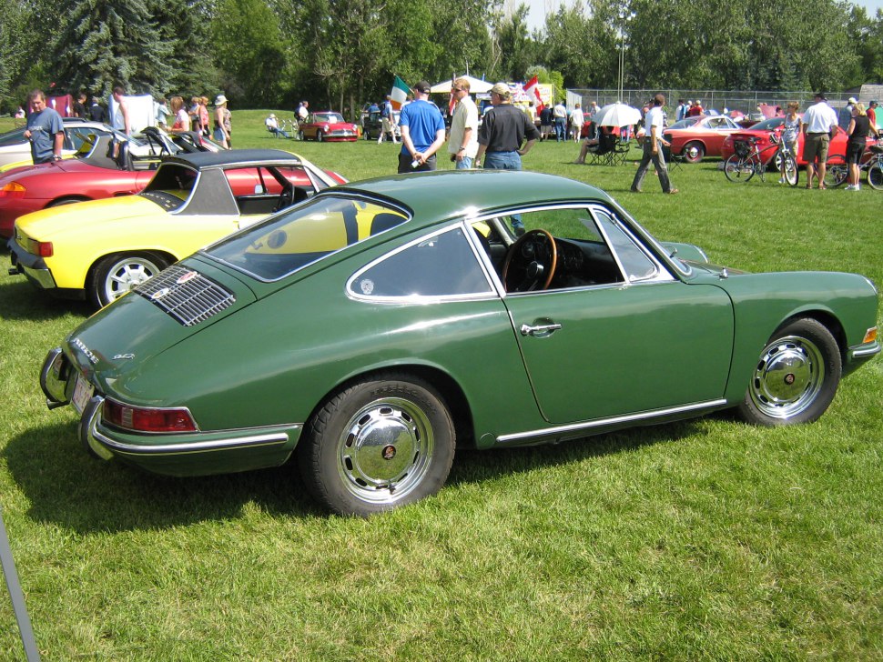 Vintage sports coupe with rear engine cover and rounded headlights