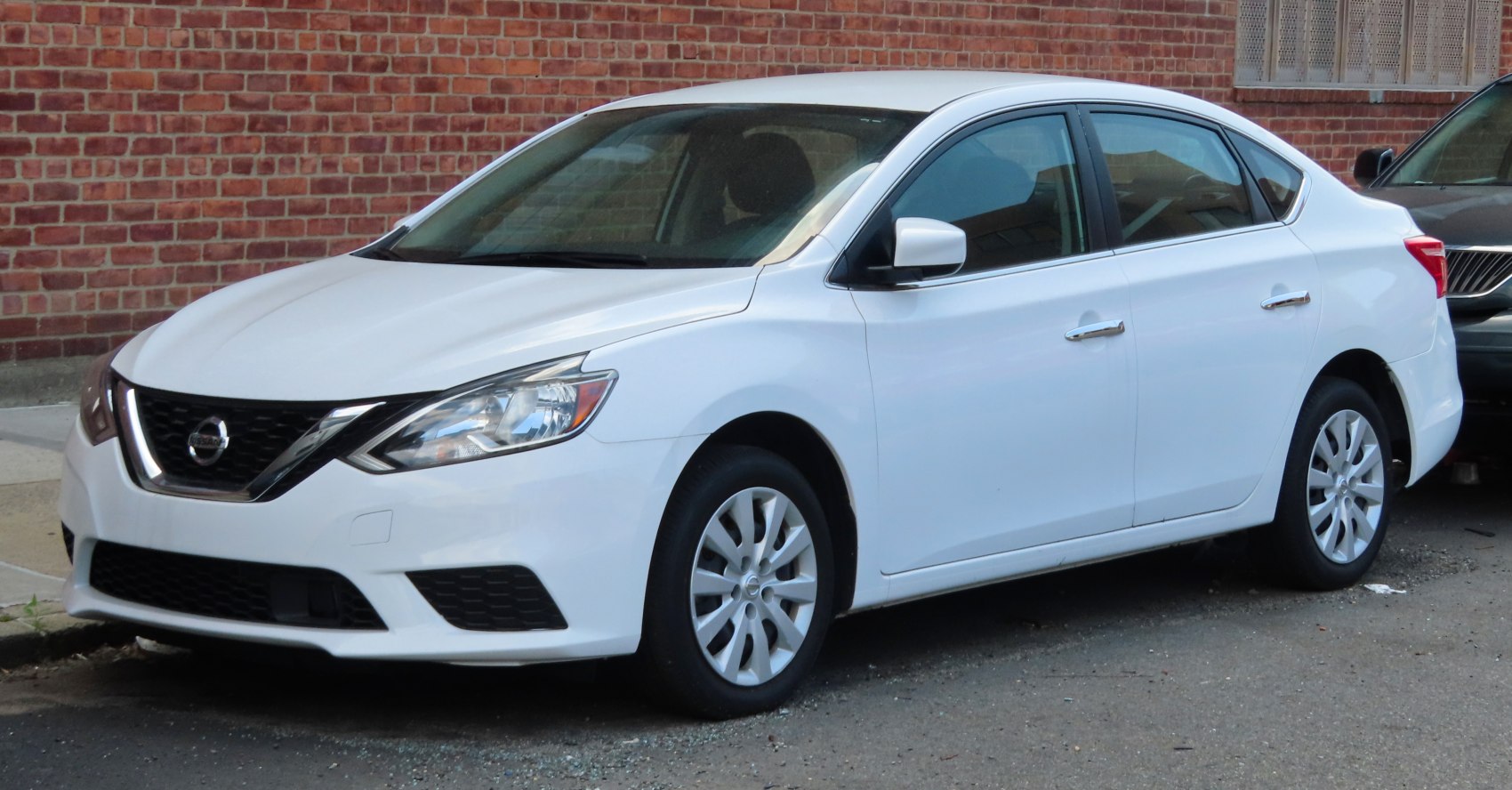 White sedan with modern headlights and alloy wheels