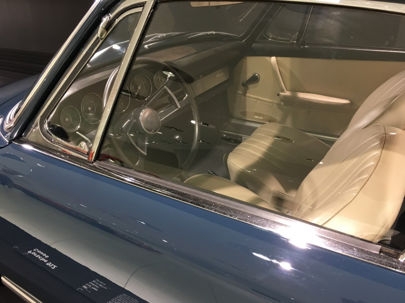 Vintage sports coupe interior with cream seats and classic dashboard