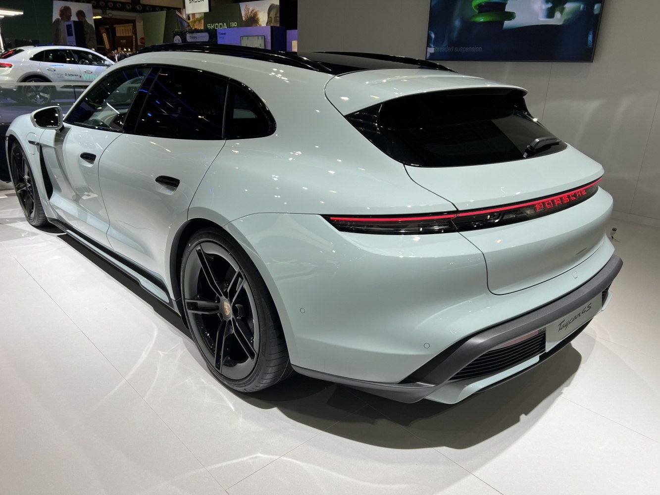Rear LED light strip and black multi-spoke rims on a modern electric sports estate