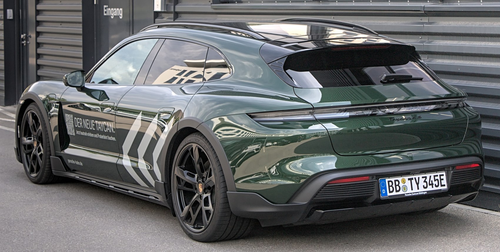 Rear sportback SUV with continuous light bar and black wheels