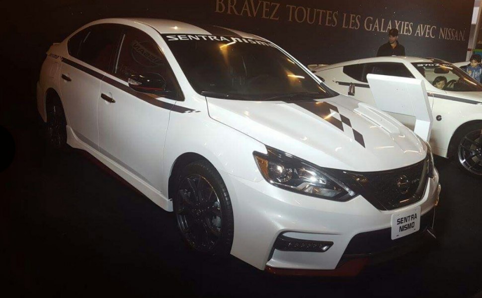 White sedan with black hood graphics and dark alloy wheels