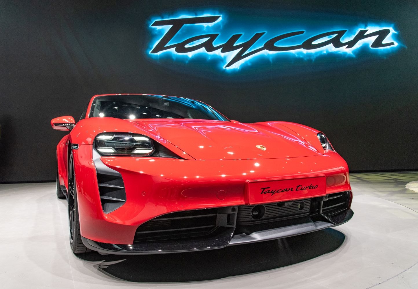 Front view of a red sports car with LED headlights and aerodynamic features