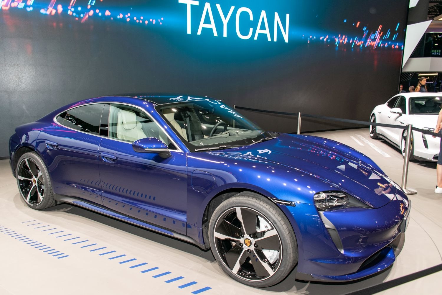 Blue electric sports sedan with aerodynamic design and performance wheels