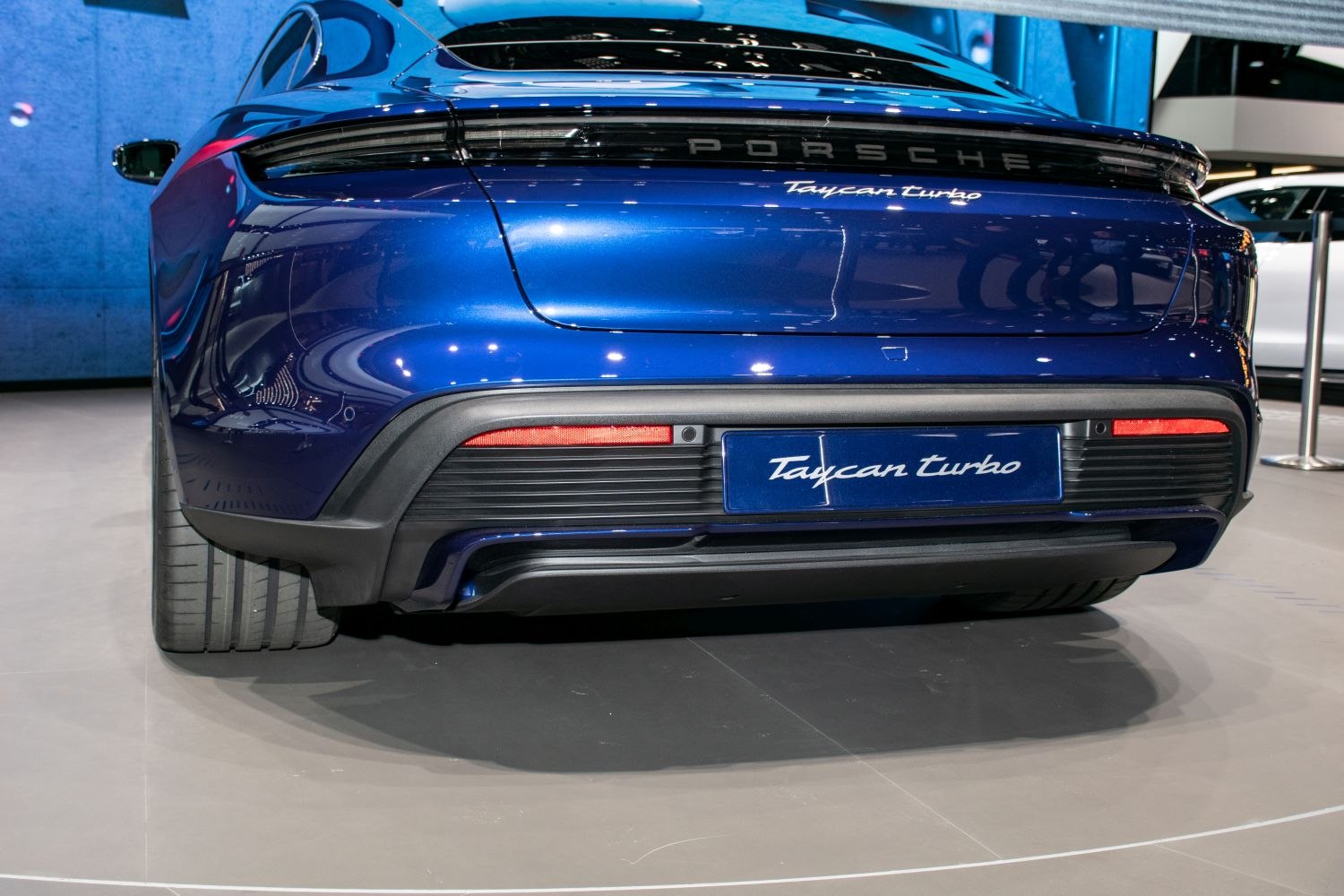 Electric sports car rear with sleek LED taillights and aerodynamic bumper.