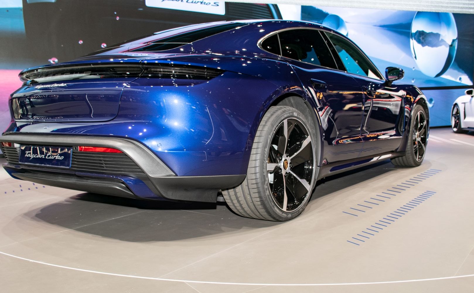 Rear and side view of luxury electric car with distinctive wheels