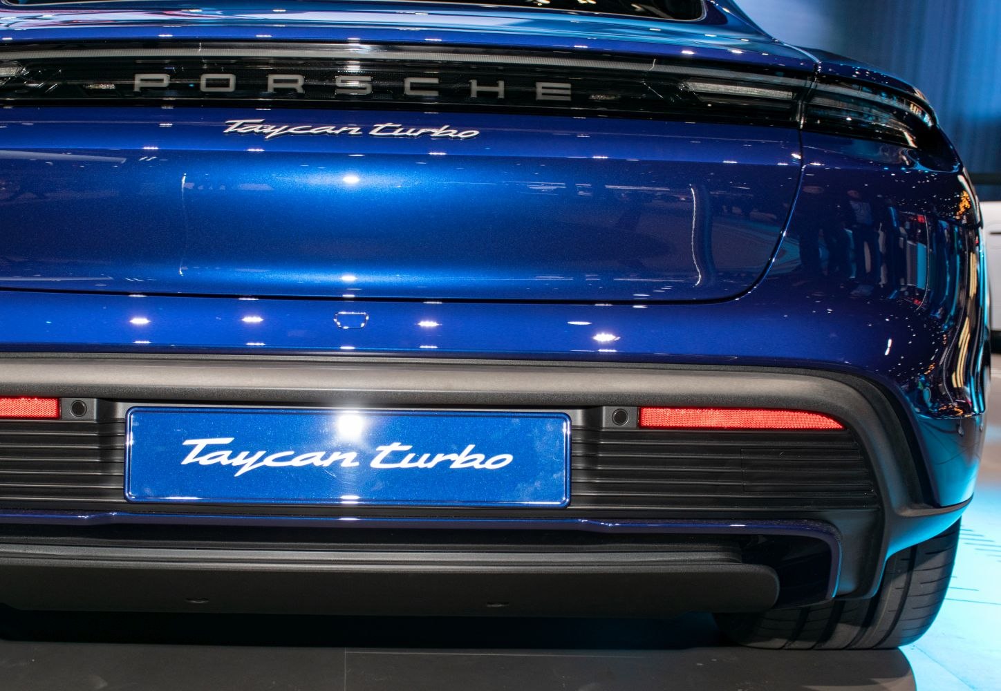Close-up of rear bumper with Taycan Turbo badge and taillight design
