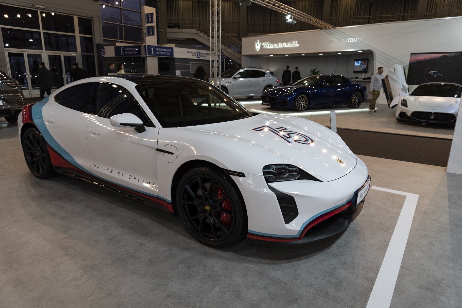 Electric sports sedan with racing stripes and black wheels