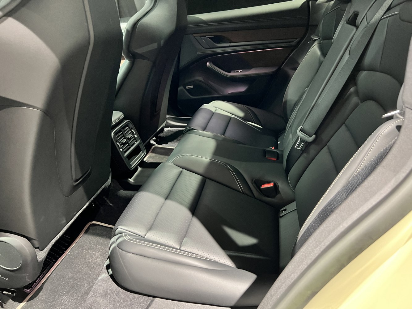 Black leather rear seats and rear air vents in a modern electric sedan