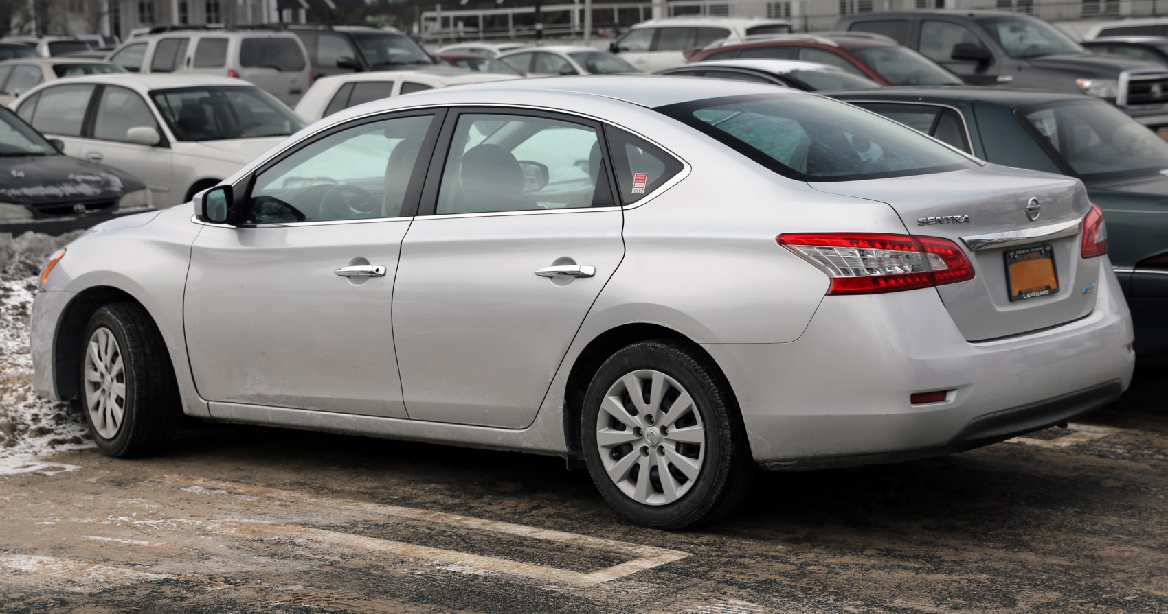 Silver mid-2010s four-door sedan with distinctive rear lights