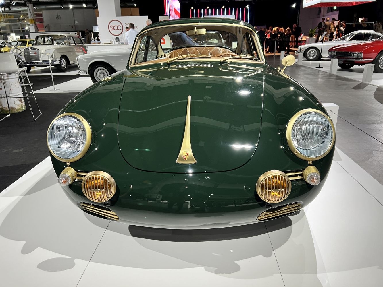 Vintage coupe front with round headlights and gold-accented fog lamps