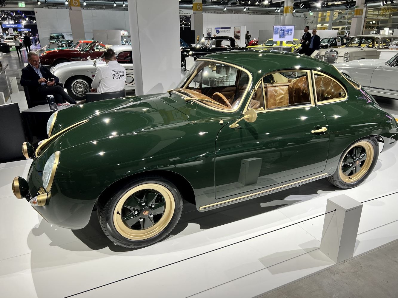 Dark green vintage coupe with tan leather interior and retro wheels