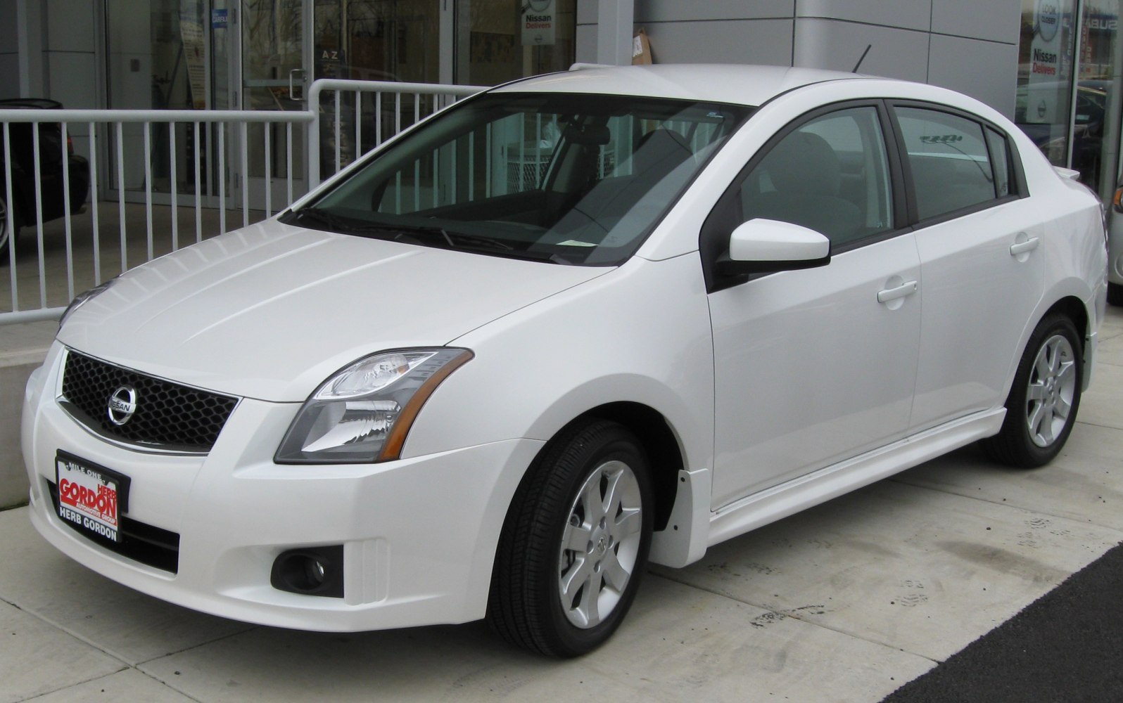 White sedan with aerodynamic body and alloy wheels