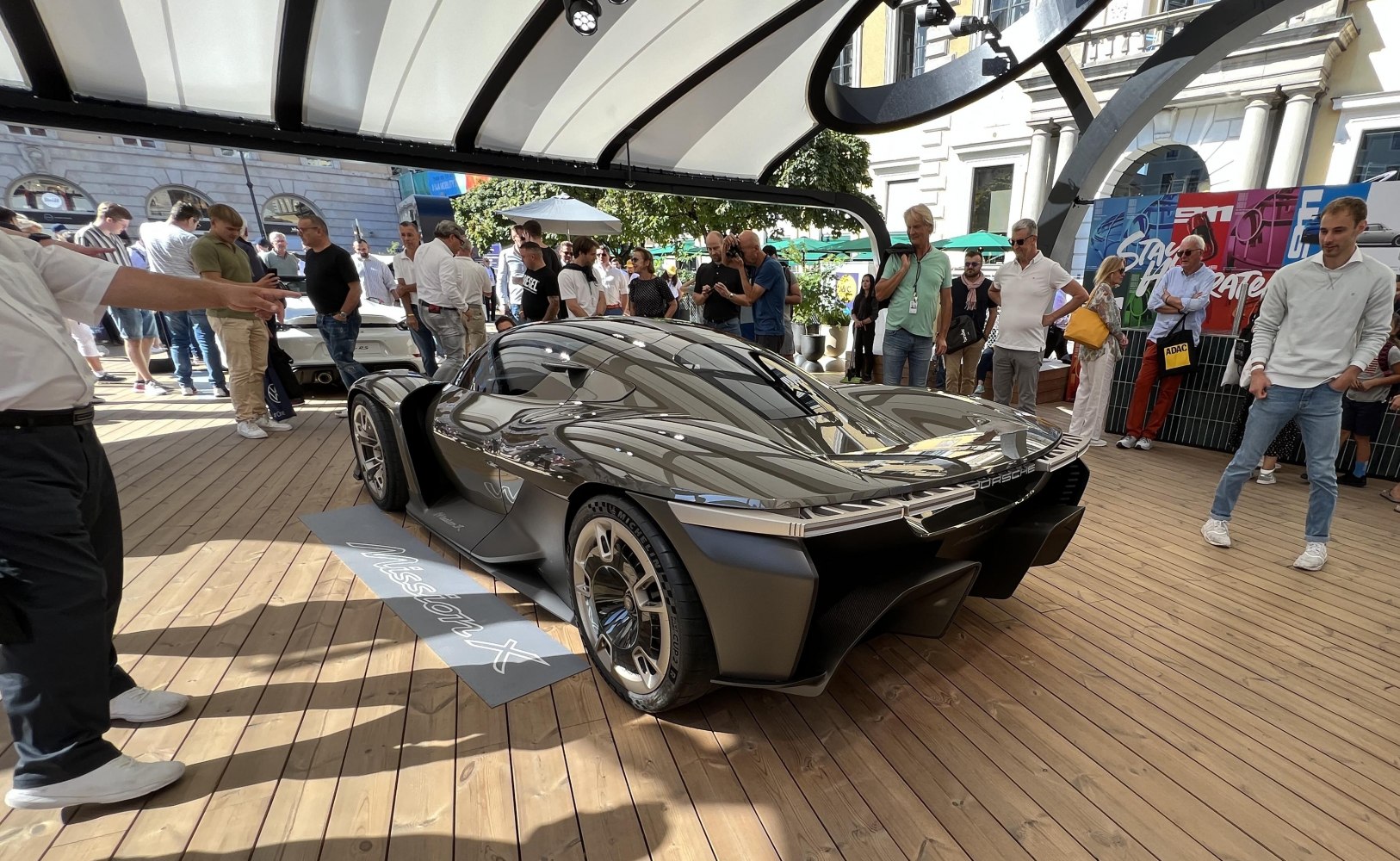 Sleek rear and side view of a futuristic supercar with aerodynamic design and distinctive wheels
