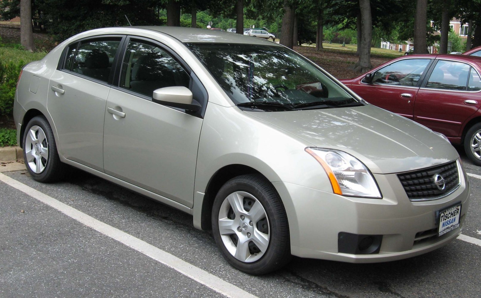 Side profile view of a sedan with alloy wheels.