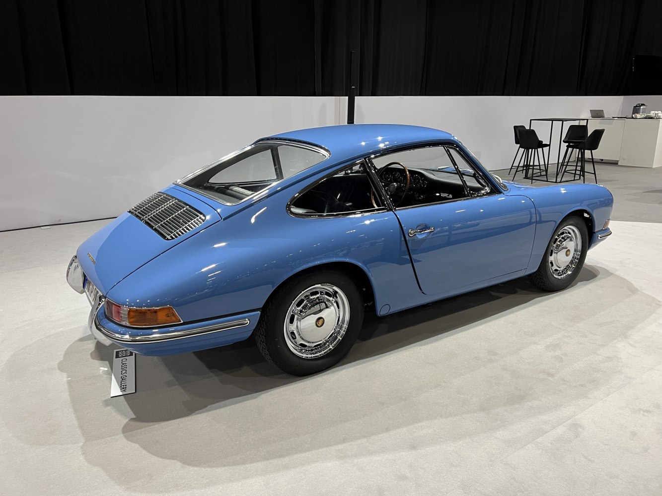Vintage sports coupe with sleek aerodynamic rear side and chrome accents