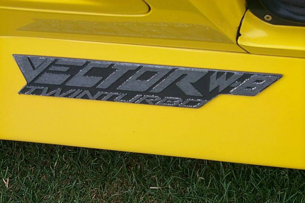 Close-up of Vector W8 Twin Turbo emblem on yellow car panel