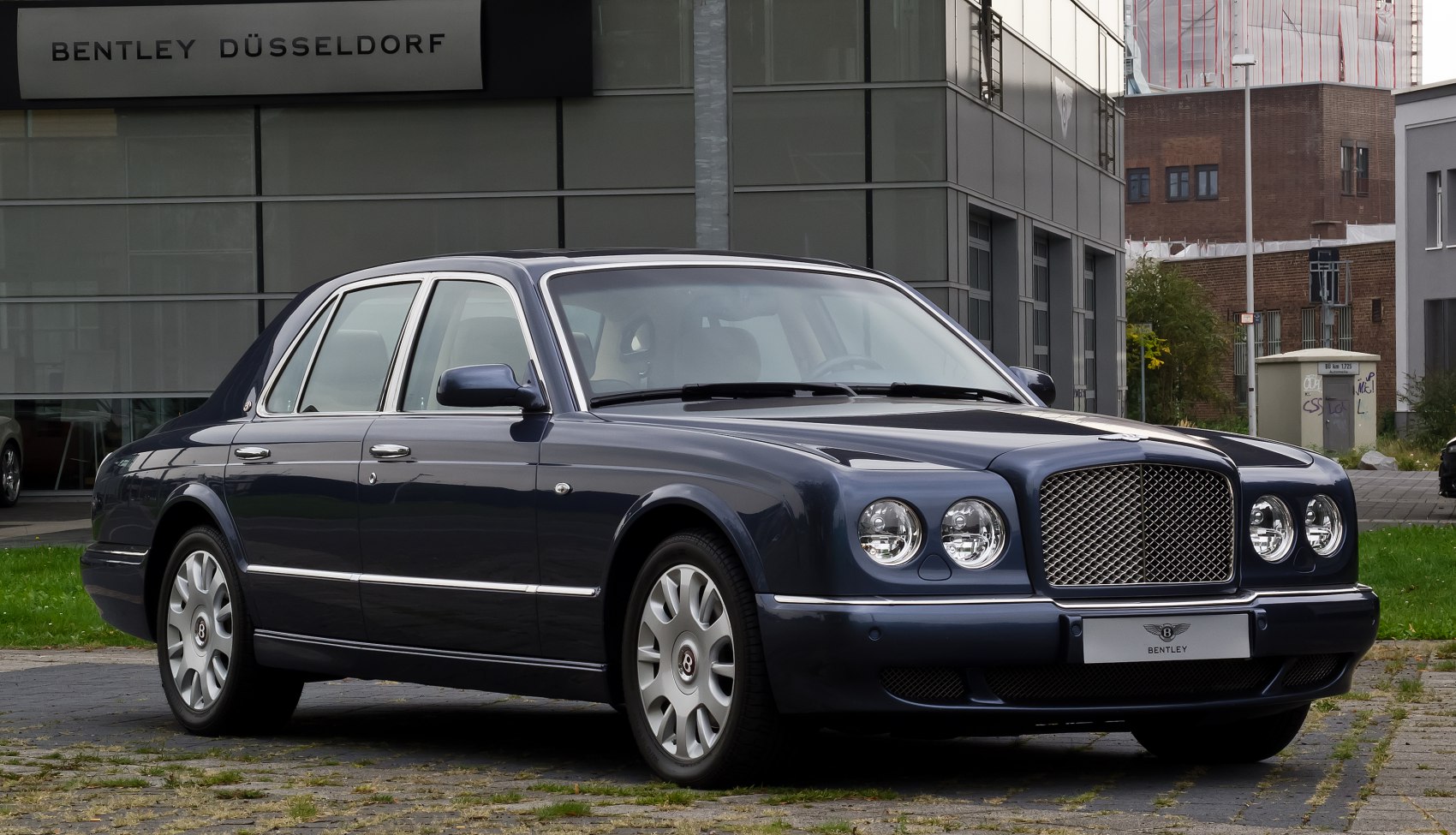 Luxury sedan with dual round headlights and iconic front grille
