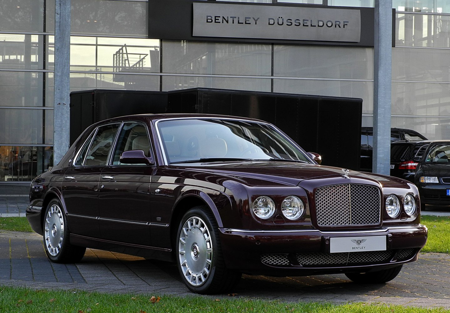 Luxury sedan with quad round headlights and distinctive mesh grille