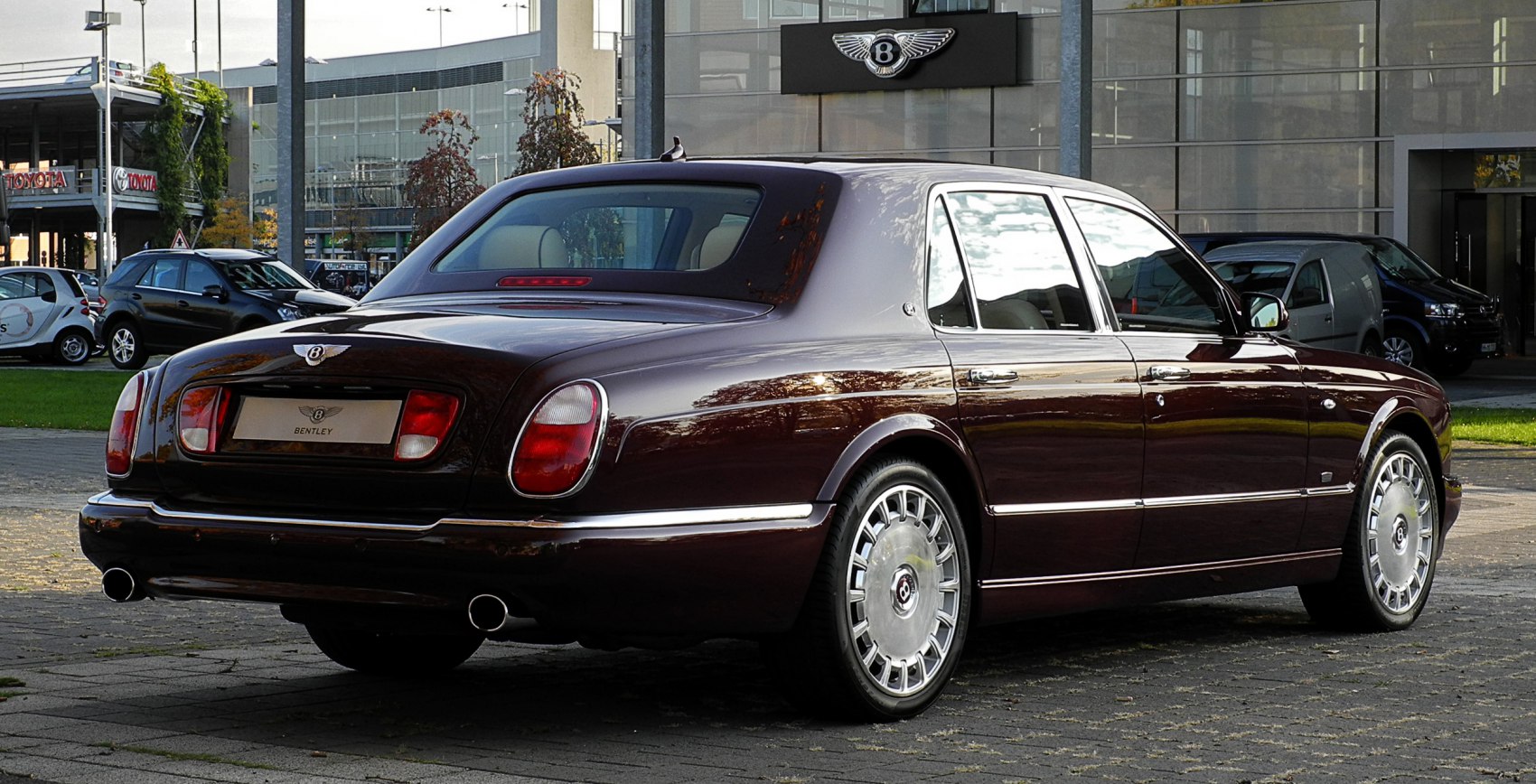 Rear view of a luxury sedan with oval tail lights and chrome trim
