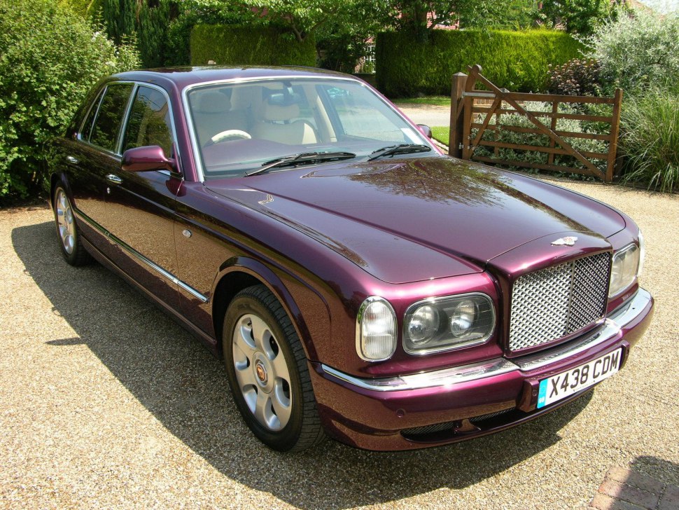 Luxury sedan with chrome grille and dual round headlights