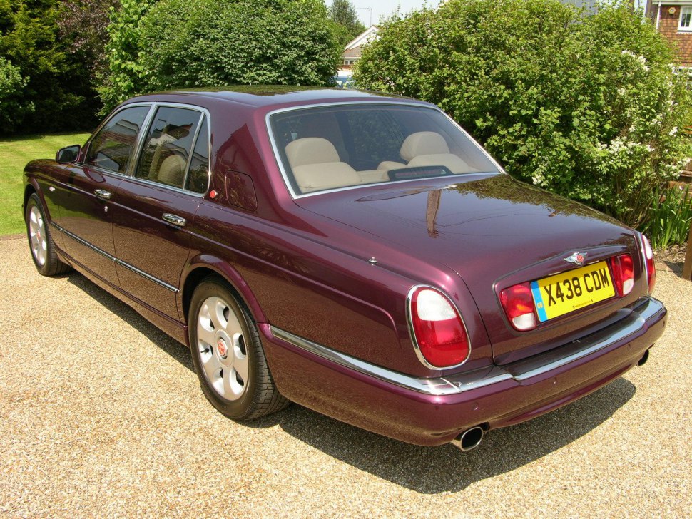 Rear and side profile of a classic luxury sedan with iconic styling details.