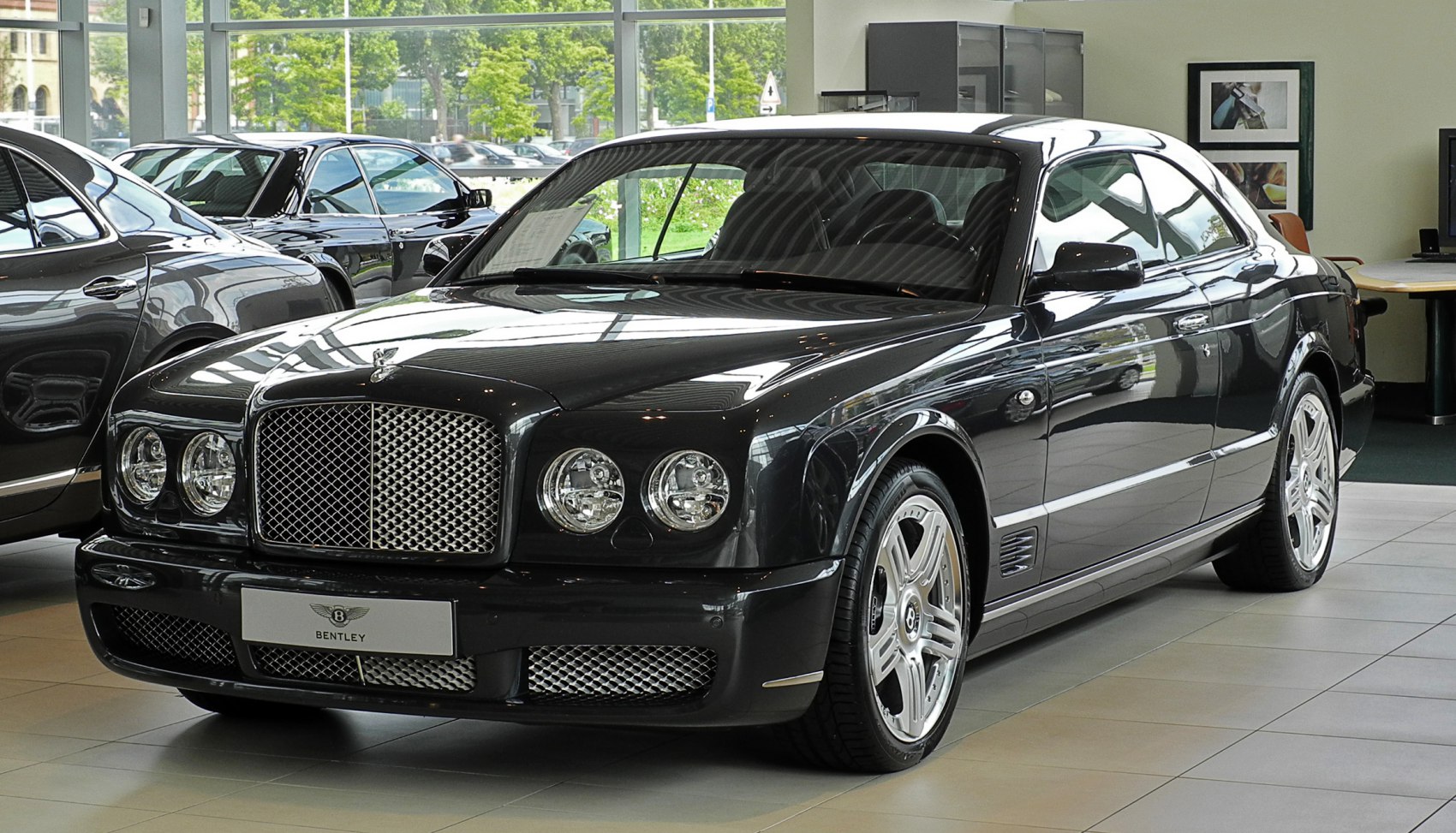 Front view with chrome mesh grille and quad headlights
