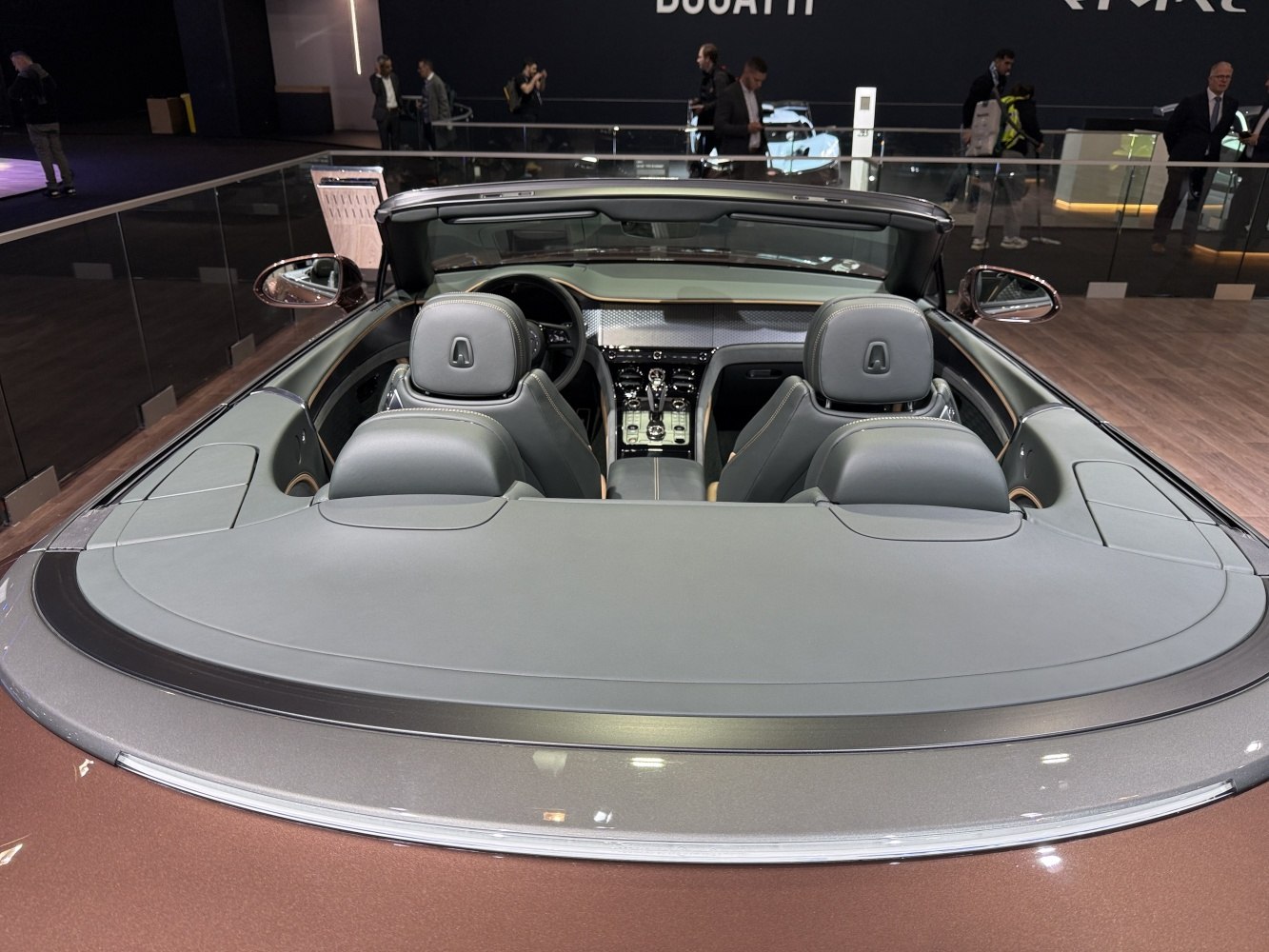 Rear and interior view of a convertible luxury coupe with leather seating.