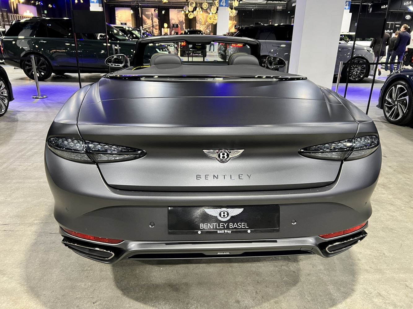 Sleek rear view of luxury convertible with distinct taillights and exhausts