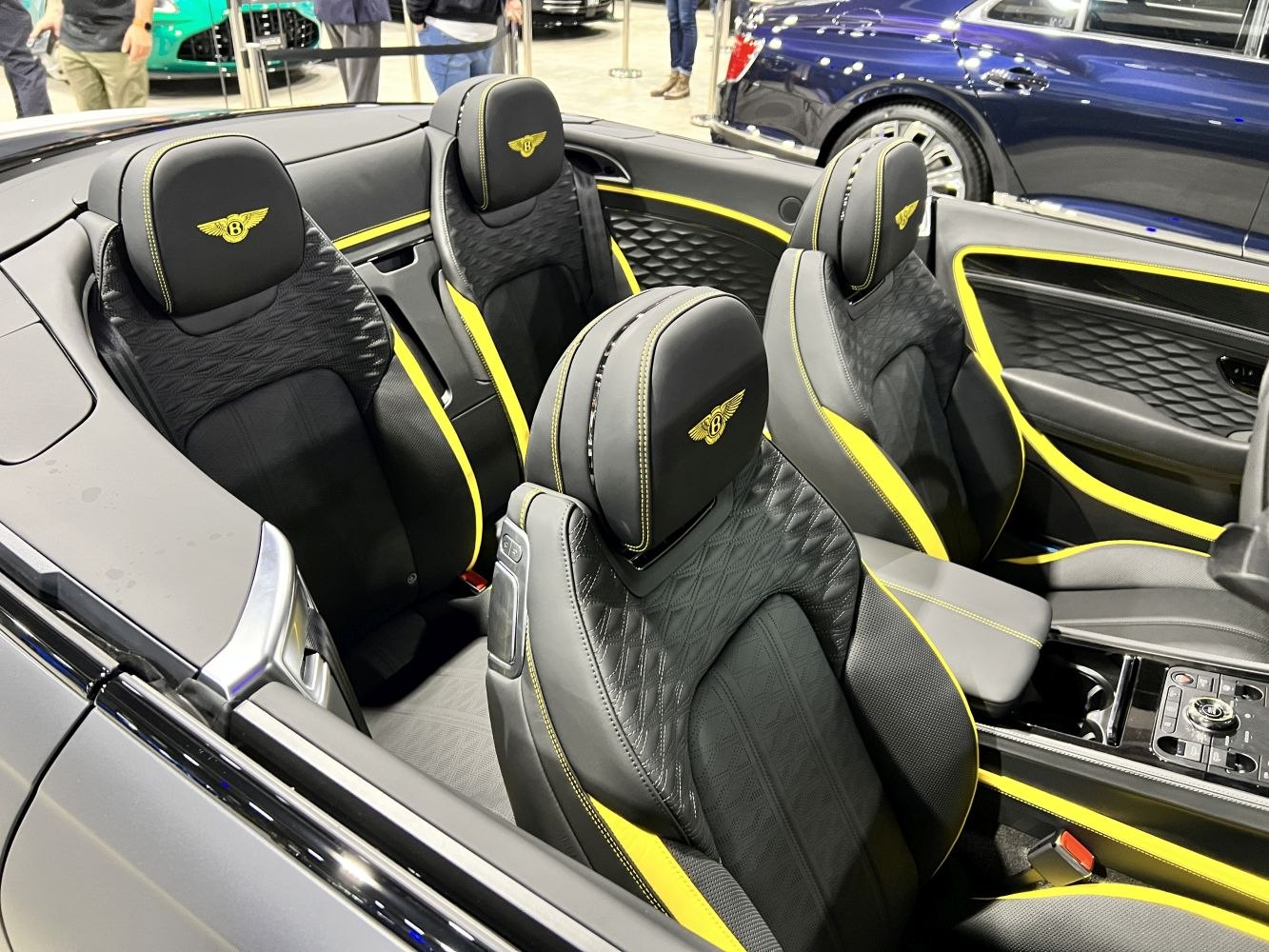 Quilted leather seats with yellow accents and embroidered logos