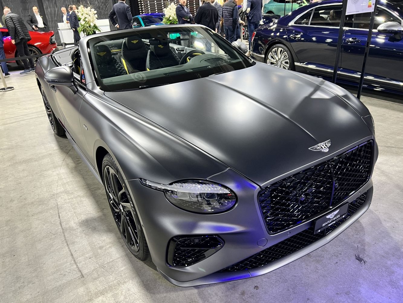 Matte grey convertible with prominent front grille and LED headlights.