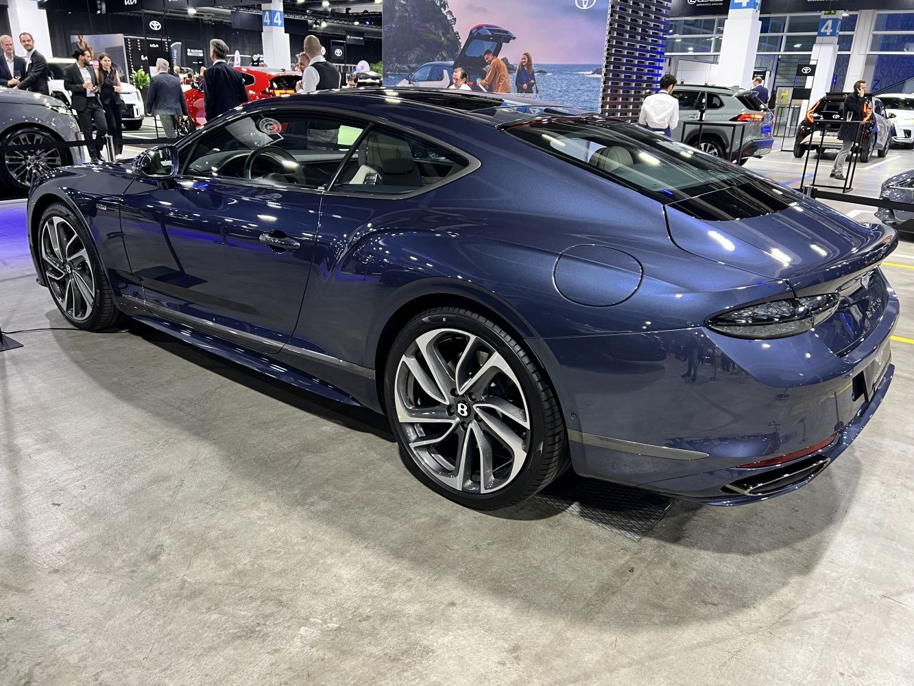 Sleek luxury coupe rear with distinctive alloy wheels