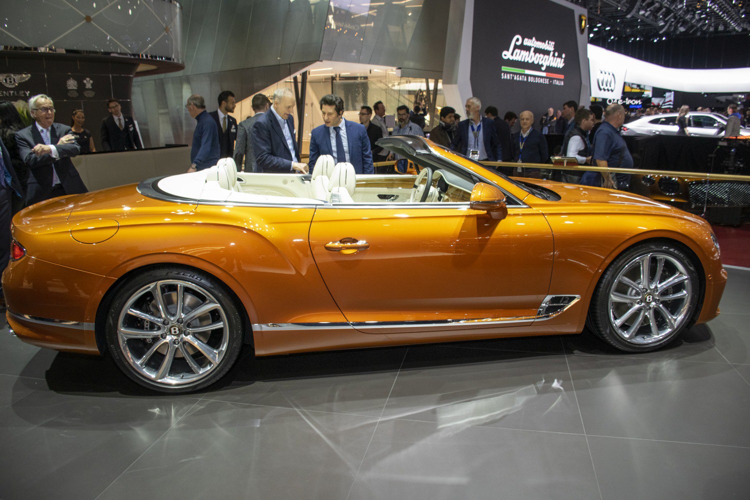 Side profile of luxury convertible coupe with open roof and alloy wheels